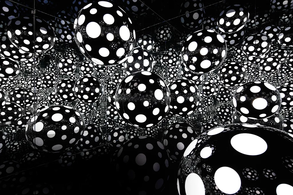 interactive exhibition at the kowloon cultural district with black and white dotted balls that are glowing