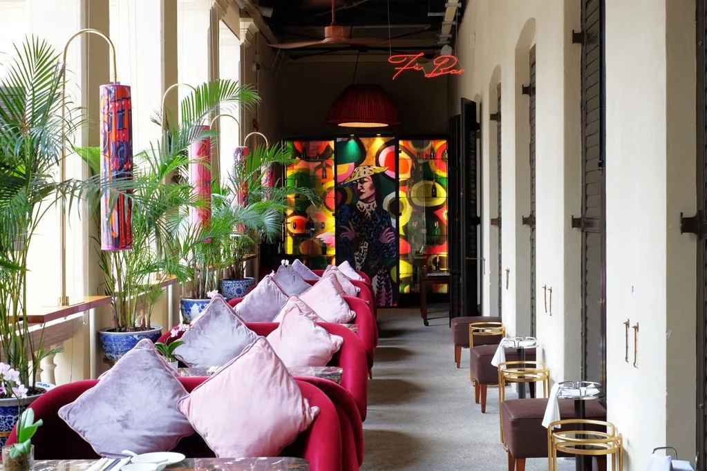 shot of hallway of restaurant at the mandarin oriental with pink cushions on booths and small stools