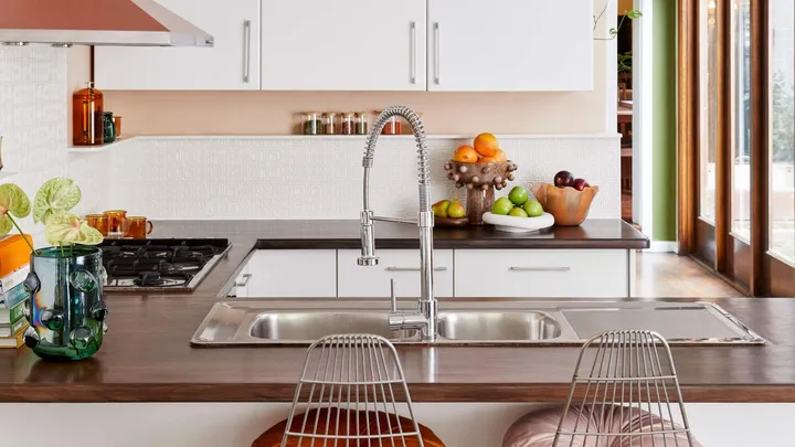 modern kitchen with white paintable wallpaper splashback and coral walls
