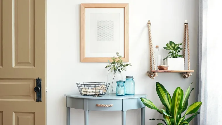 wall table in pastel blue with rope wall hanging