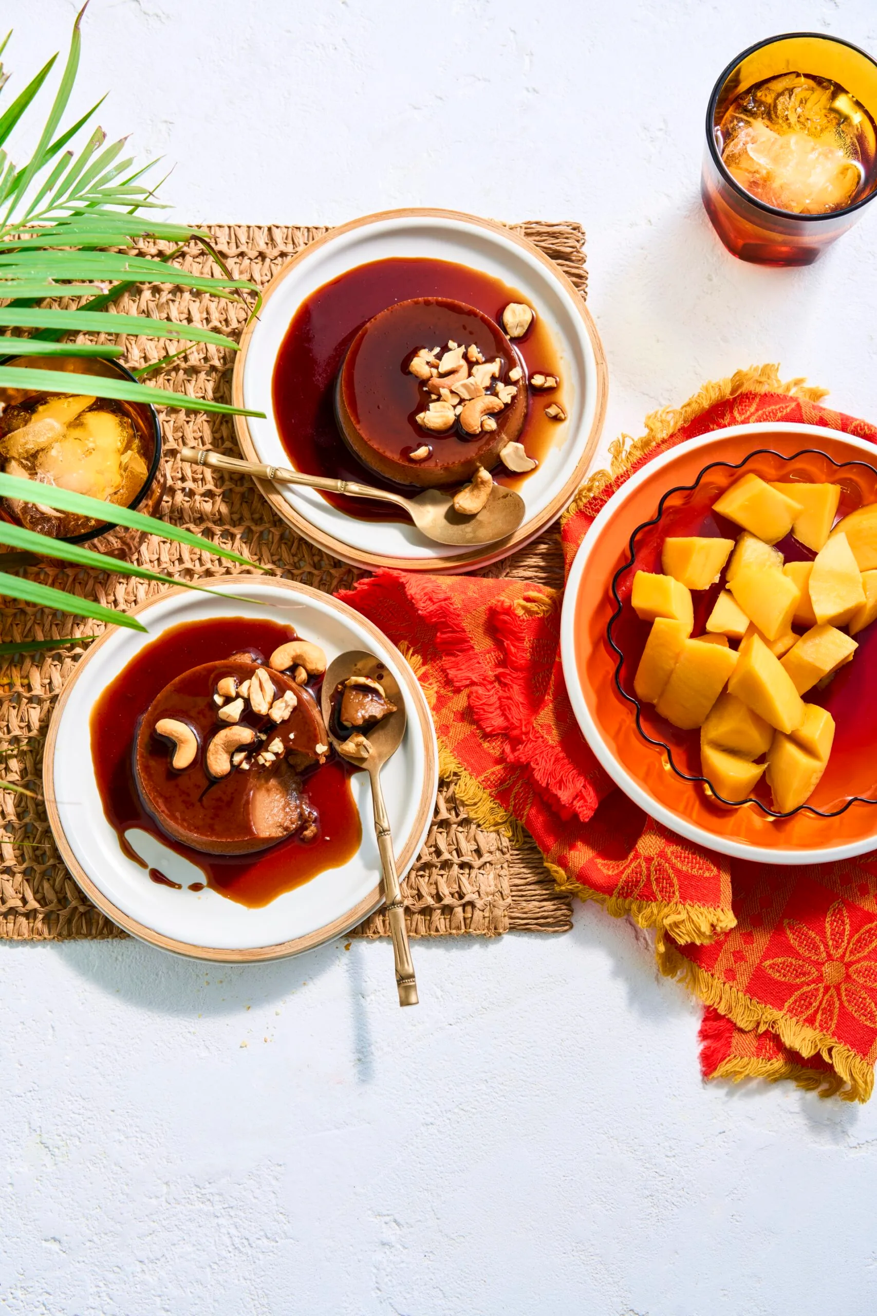 two bowls with creme caramel done like sri lankan watalappan with bowl of mango on the side