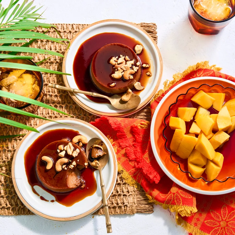 two bowls with creme caramel done like sri lankan watalappan with bowl of mango on the side