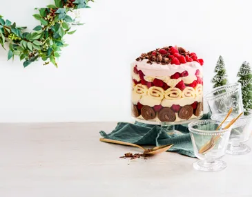 faraway shot of trifle with garland hanging from wall behind