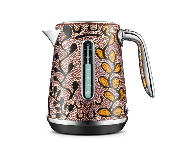 Colorful electric kettle with an abstract pattern of dots and leaves, featuring a clear water gauge and metallic handle.