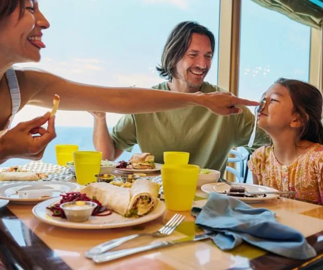 Family eating food and playing around on a Carnival Cruise