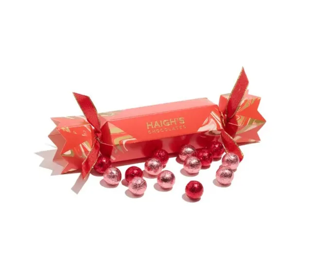 haighs red bon bon with chocolates spilling out of it