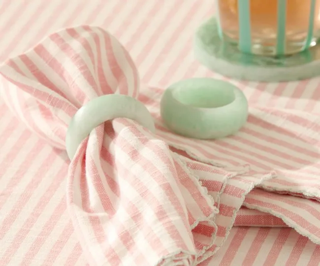 christmas theme table with pink gingham napkins and blue marbled resin holder