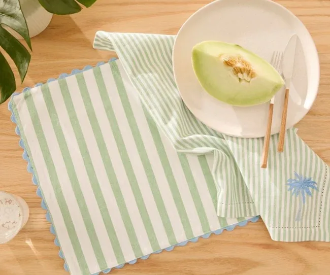 christmas table theme with melon in bowl and hero of striped napkin in light green and white