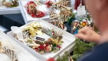 wreath with person looking to buy it from sydney christmas market