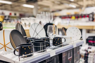 A selection of dinnerware on display in a department store.