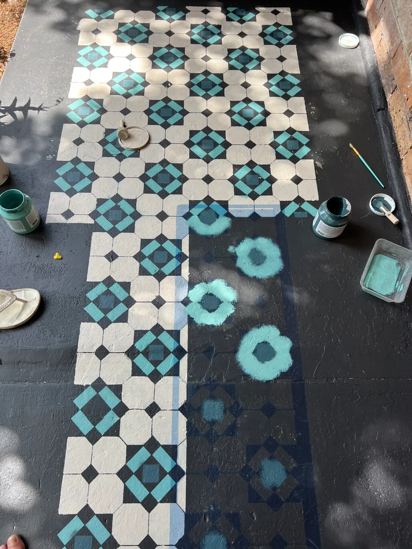 porch floor with stencils and paints in progress