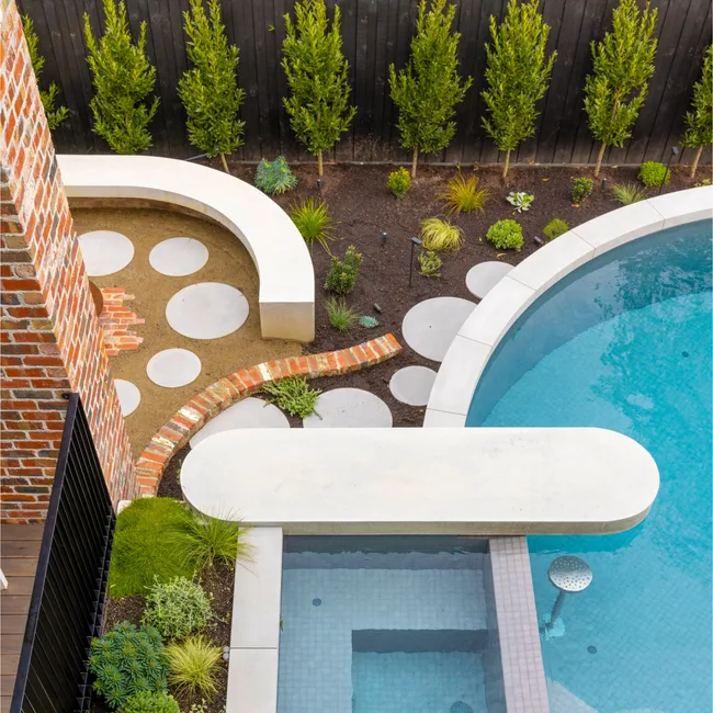 landscaped pool with curved pavers and design