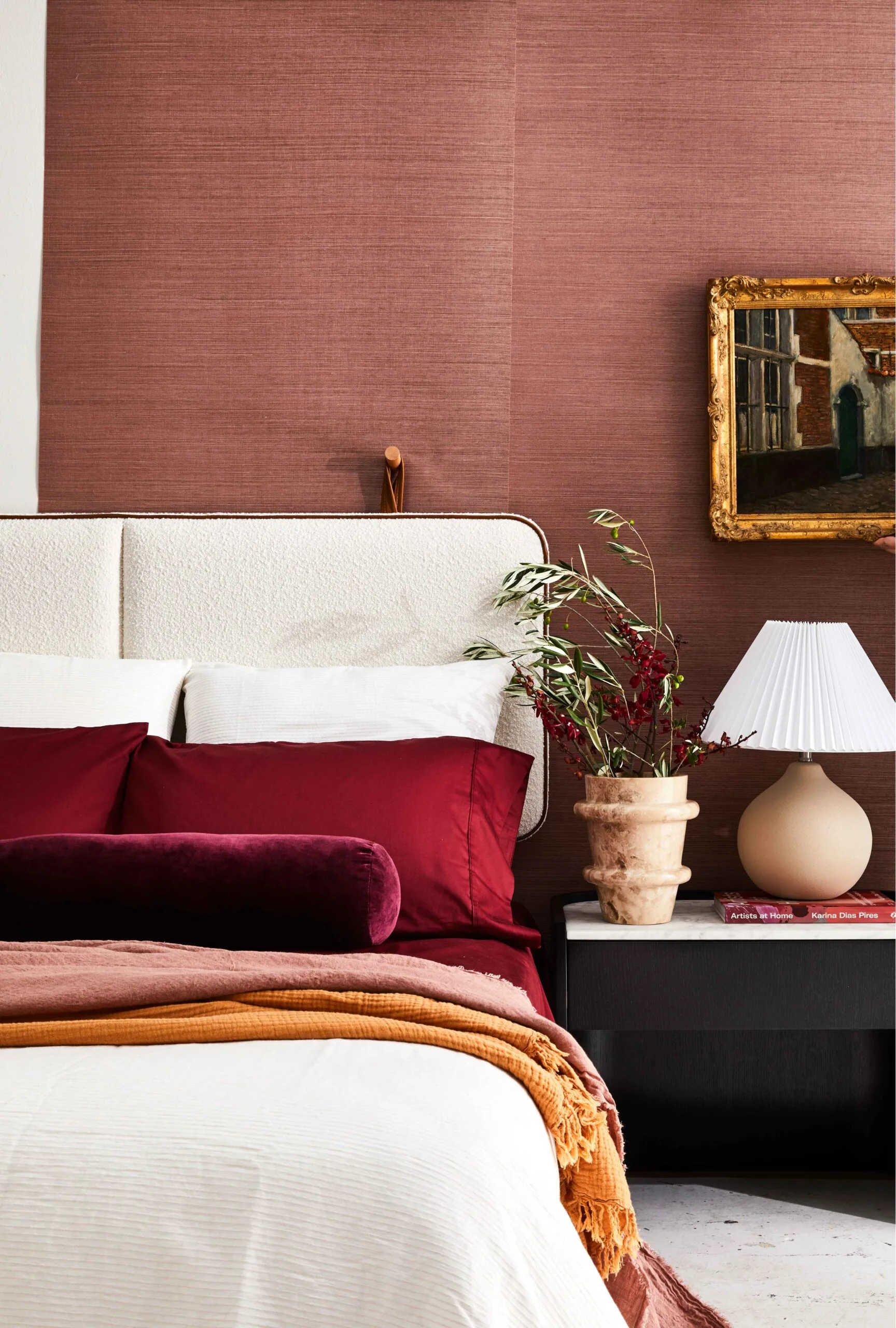 bed with white sheets and burgundy pillows