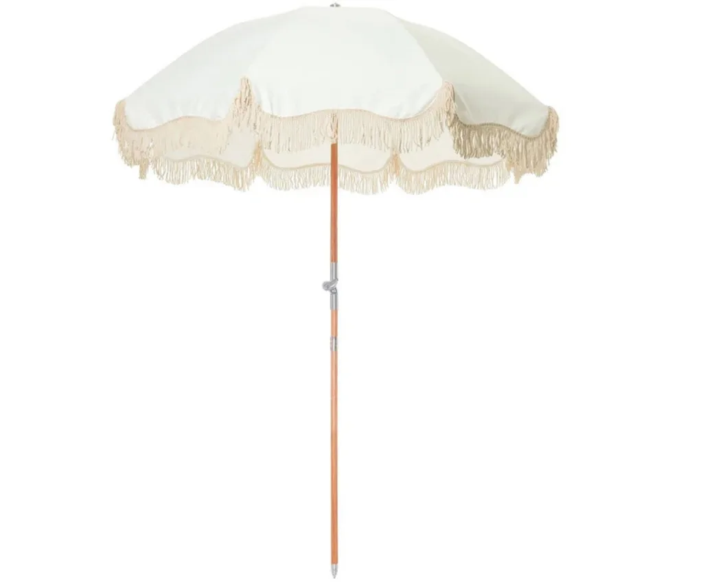 fringed best outdoor umbrella with beige colouring and wooden pole