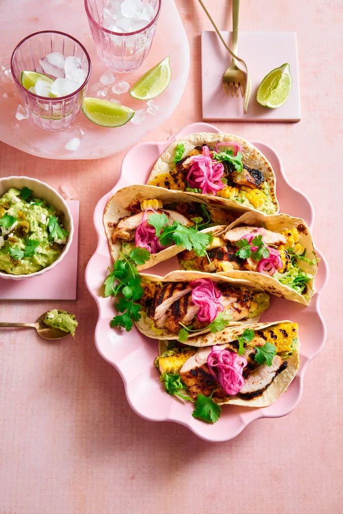 chicken tacos on pink plate