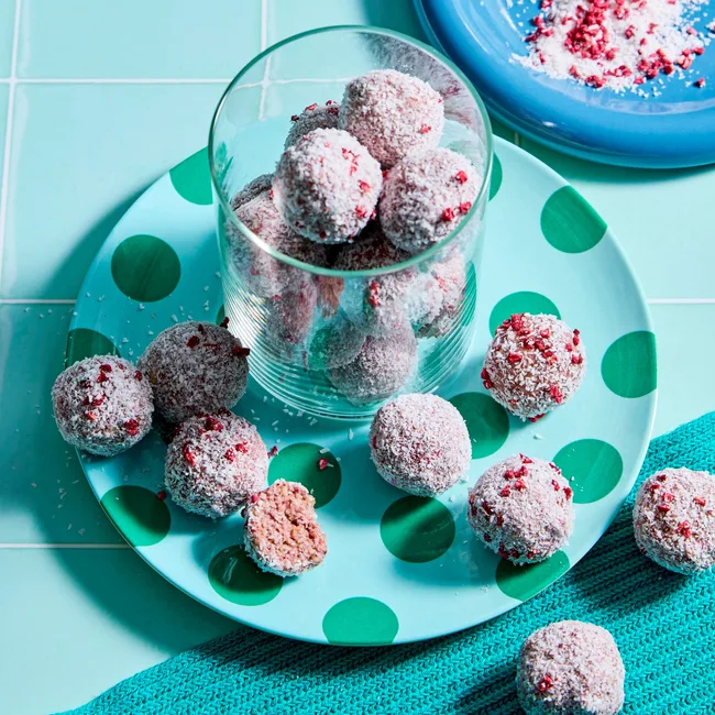 coconut chocolate balls in cup on blue background