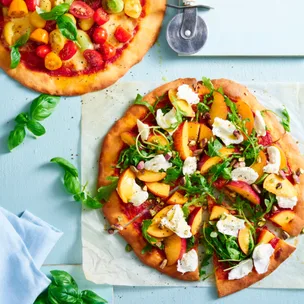 flatbread pizza with peach mozzarella and basil on top