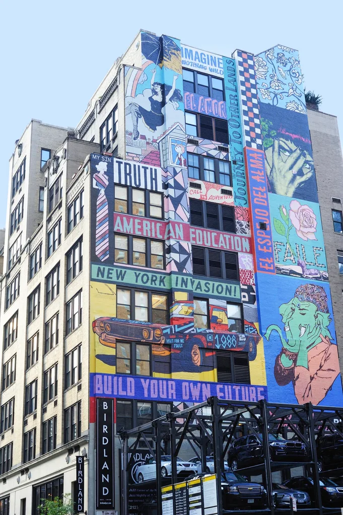 painted building with cartoons and artsy words