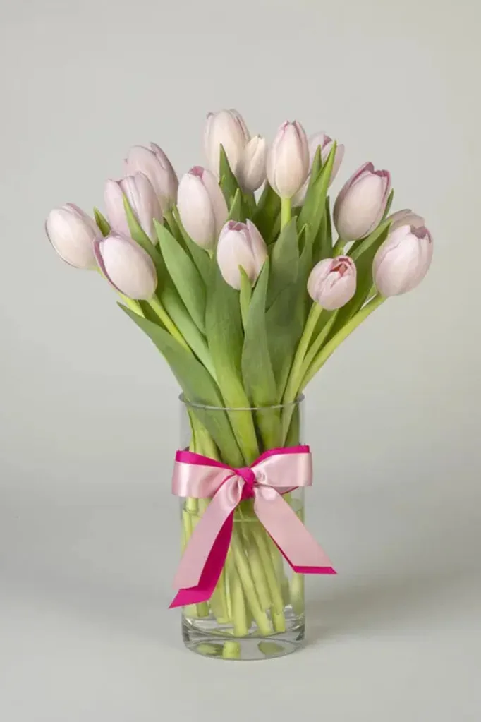 tulip mother's day flower bouquet with pink ribbon tied around the front