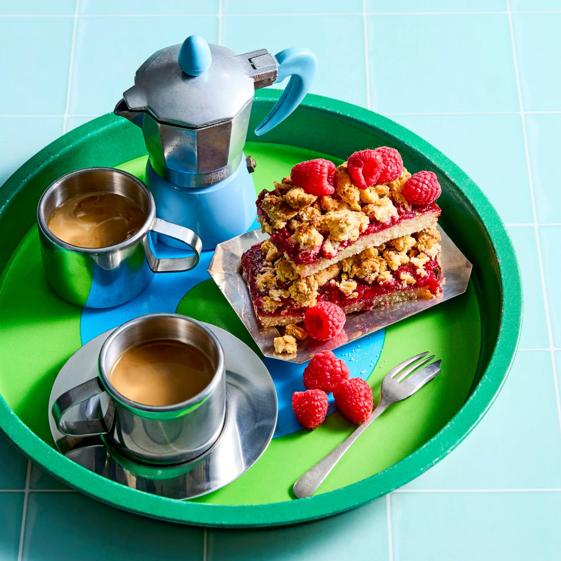 cups of coffee with a cake beside it