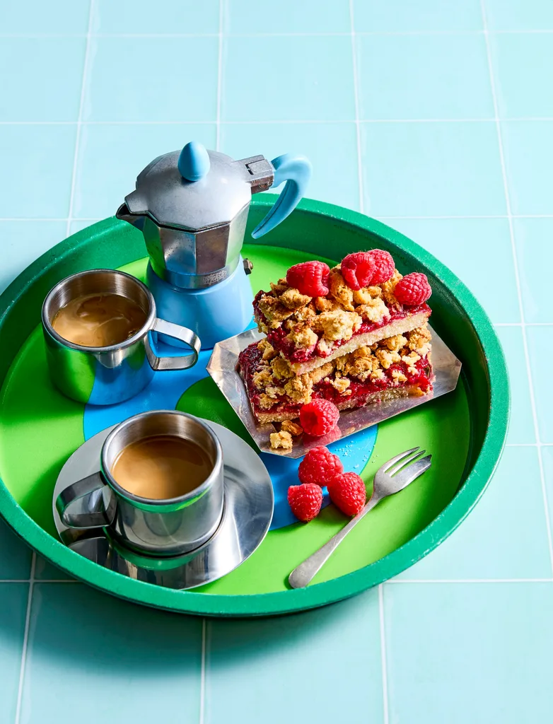 cups of coffee with a cake beside it