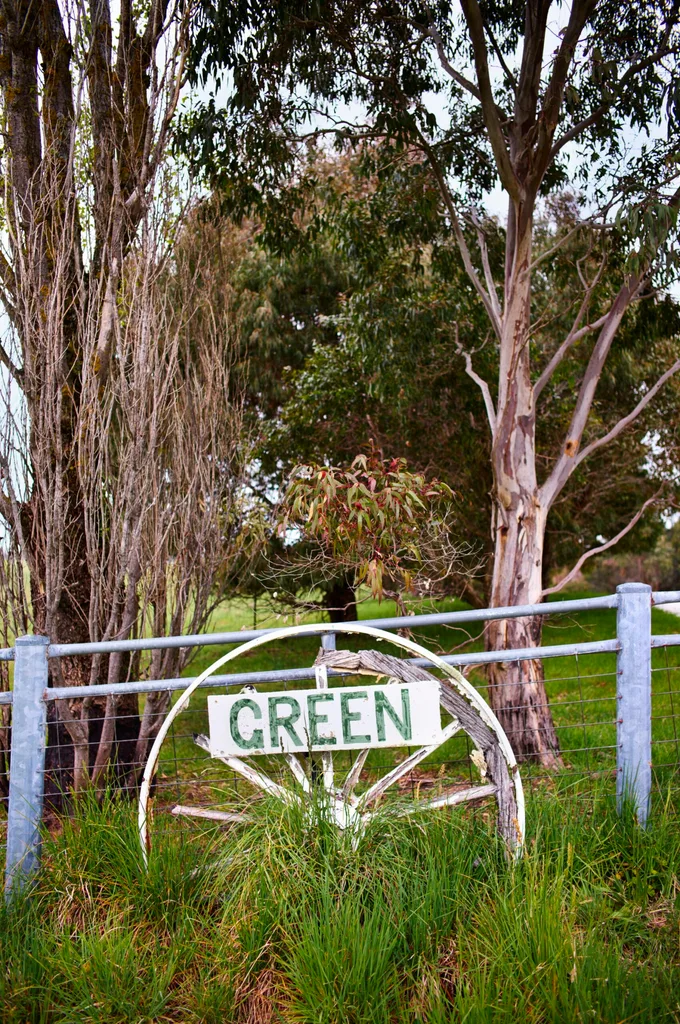 farm with a large wheel and sign reading 'green'