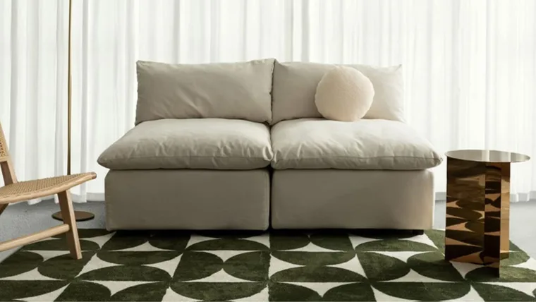 best washable rug with green geometric design with white leather couch and gold mini table