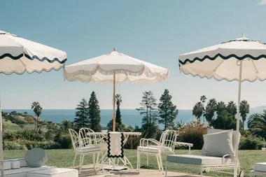 outdoor umbrellas with nice navy r=trim surrounded pool scene with metal chairs