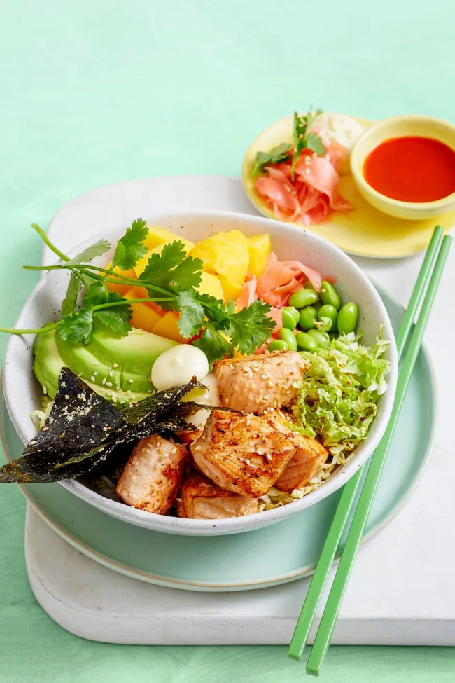 easy poke bowl recipe with salmon vegetables edamame and chopsticks and ginger on the side