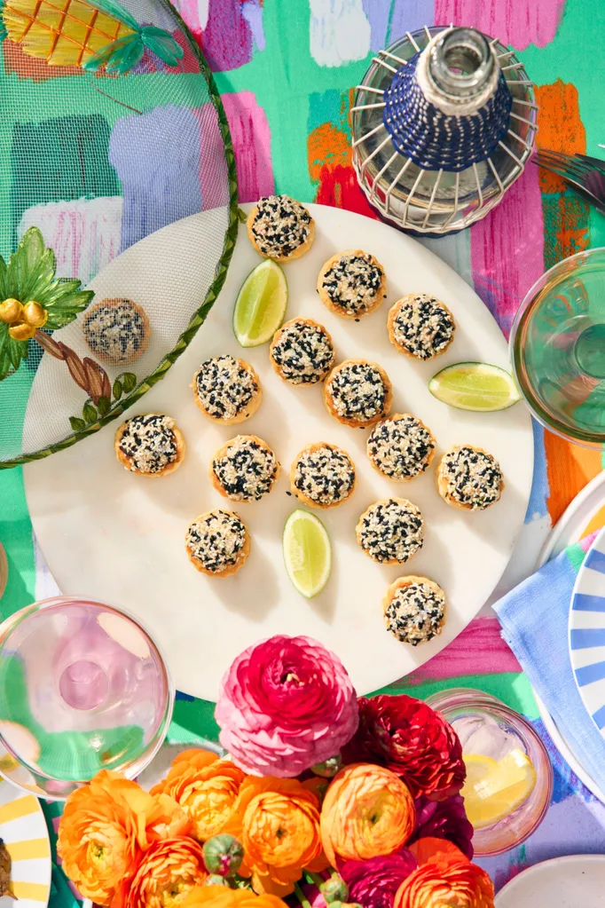 prawn toast on a white plate and colourful table cloth