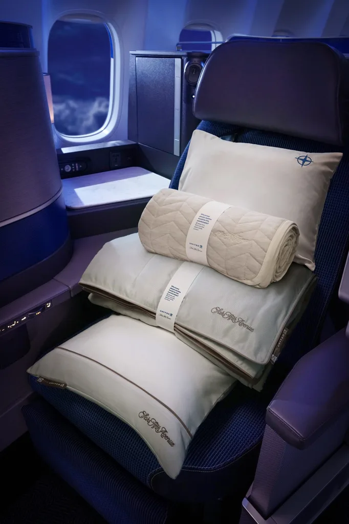 image of sleep set up on untied polaris business class flight with pillows and two blankets layered on top of each other