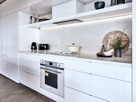 kitchen with oven built in and white cupboard surrounding it