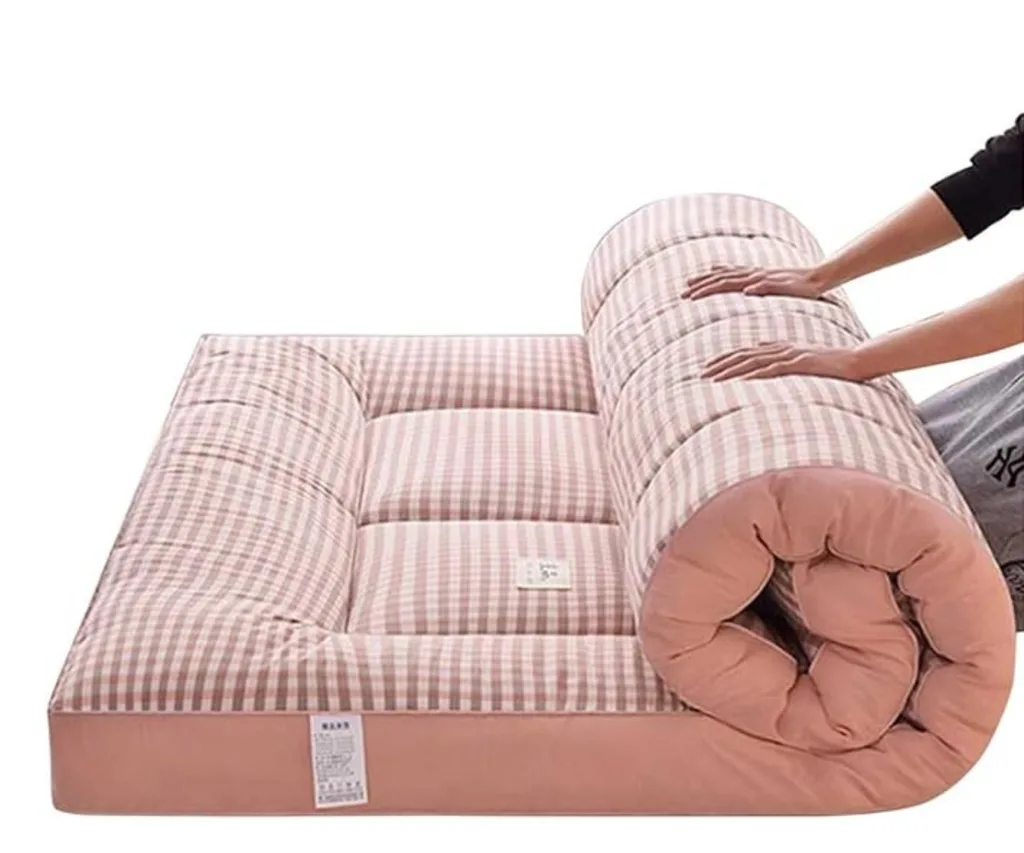best foam mattress in pink gingham design being rolled up