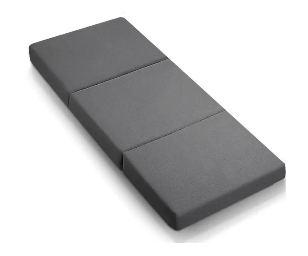 foldable foam mattress laid out on the ground