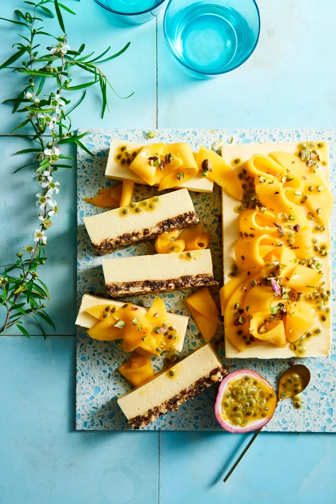 mango cheesecake slice on a blue board