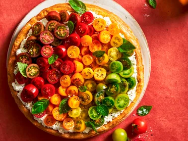 tomato tart with different coloured cherry tomatoes on top in line