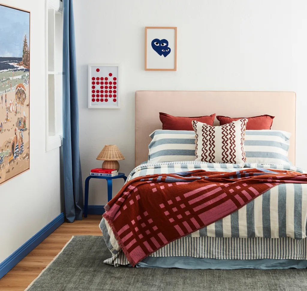 Bedroom decorated with blue and rust-coloured bedding