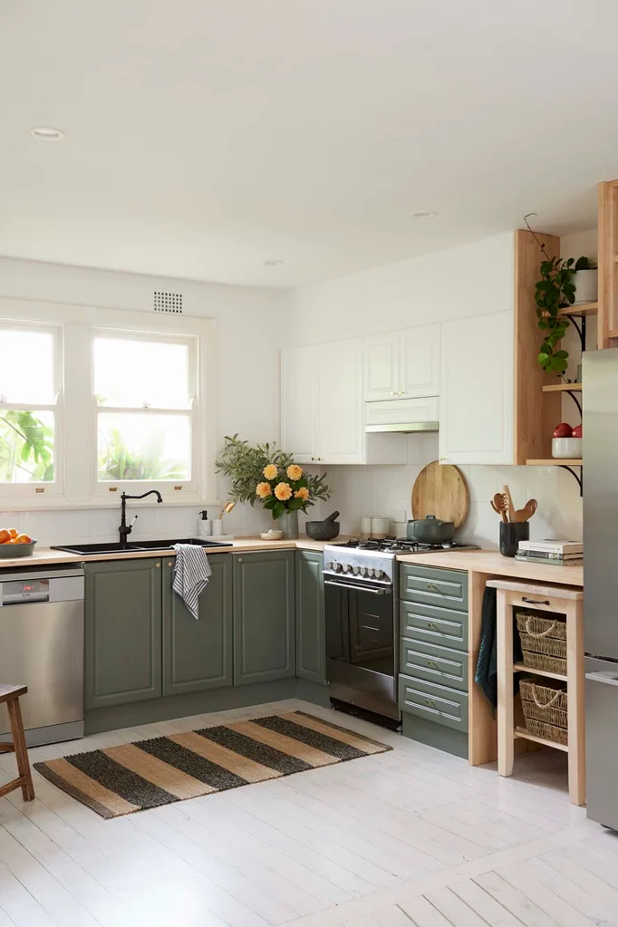 green kitchen cabinets with wooden benchtop and open cupboards on the left