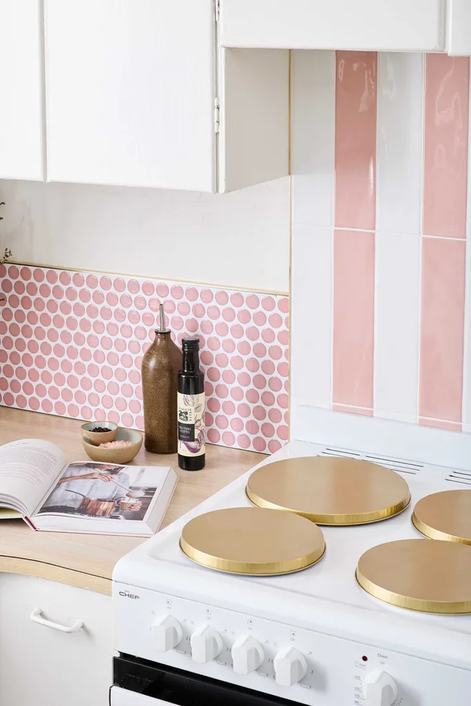 White rental kitchen given makeover with stick on splashback tiles and stove covers