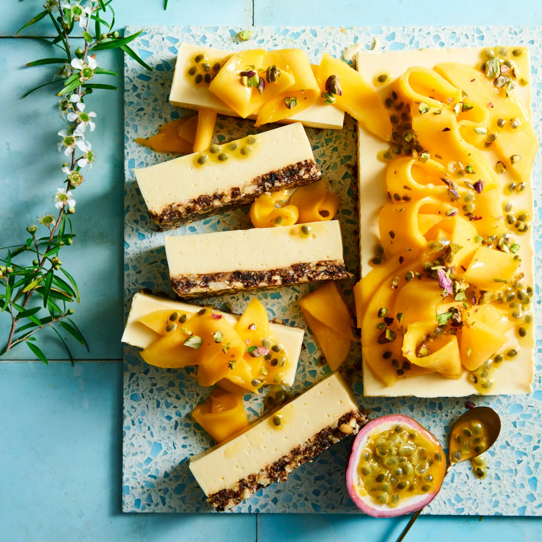 mango cheesecake slice on a blue board