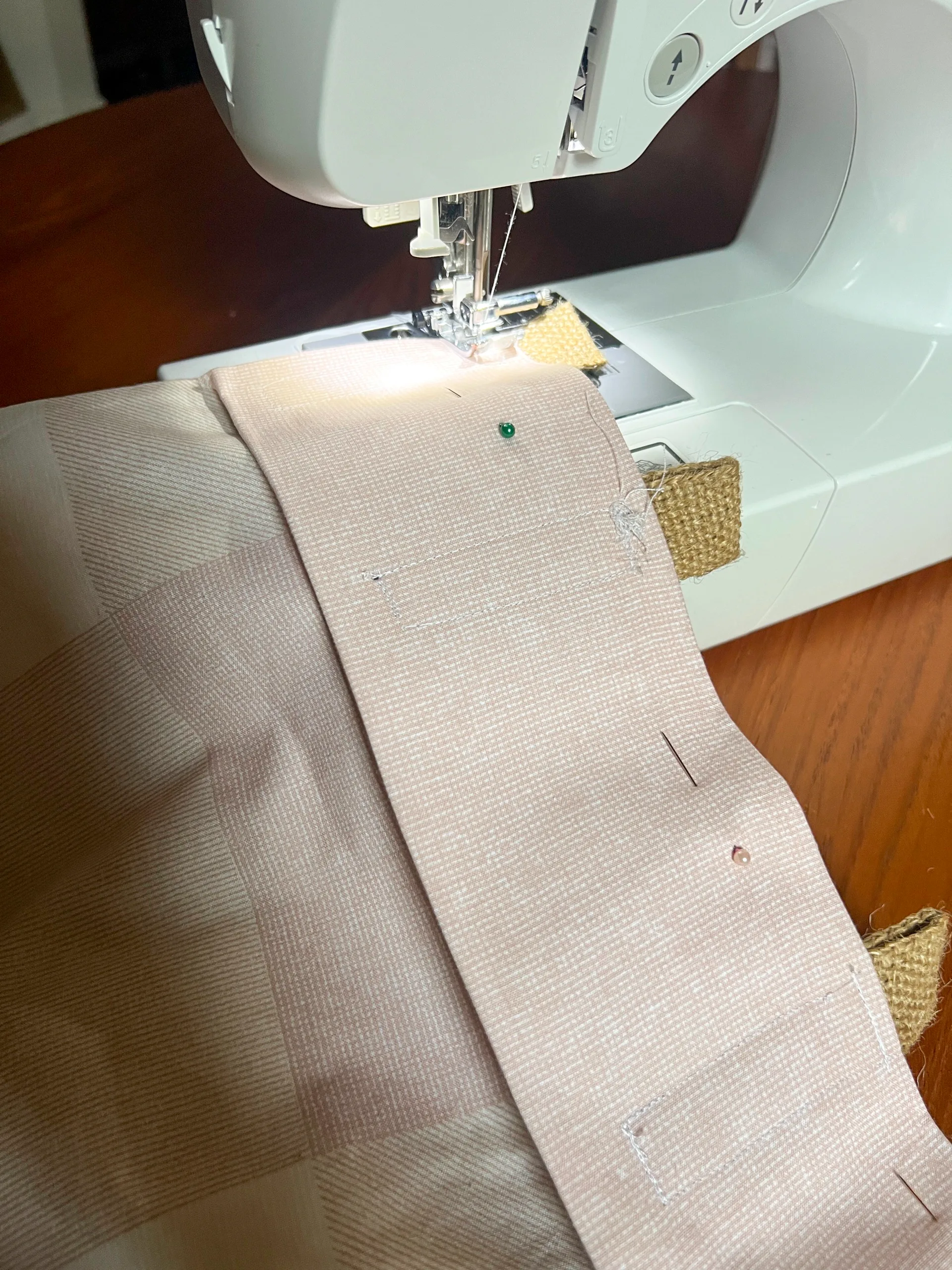 sewing machine and pink fabric project in progress