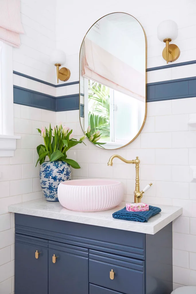 bathroom with pink and blue tiles and gold accents. Make sure your tradie red flag of being on time doesn't mean your time period is extended