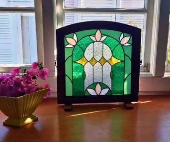 Stained glass sun catcher in a stand inspired by art nouveau movement