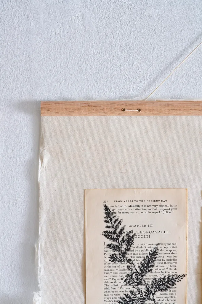 close up of wooden dowel thats holding up craft artwork