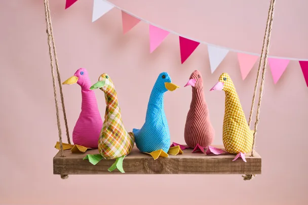 duck doorstops made of fabric on hanging swing with bunting behind