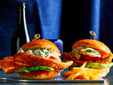 crispy fish burger with skewer sticking out of the top
