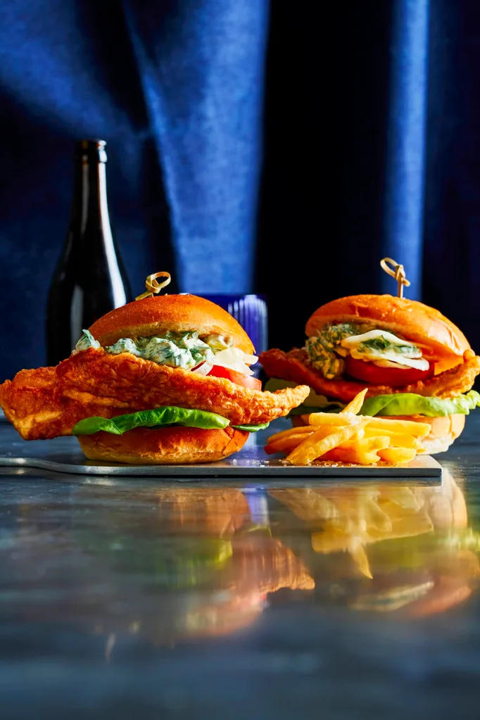 crispy fish burger with skewer sticking out of the top