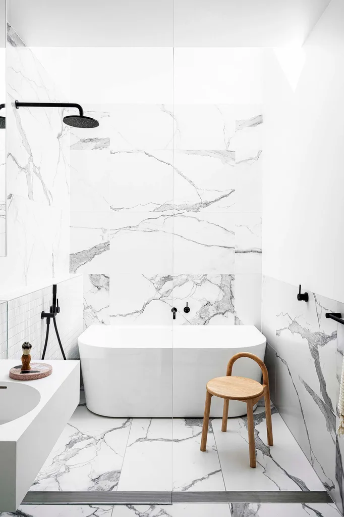 White and marble bathroom with timber chair