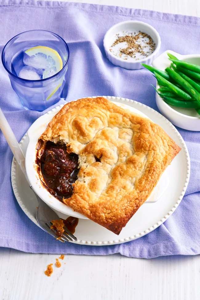 pie for one with spoon cut out of it on a purple tablecloth