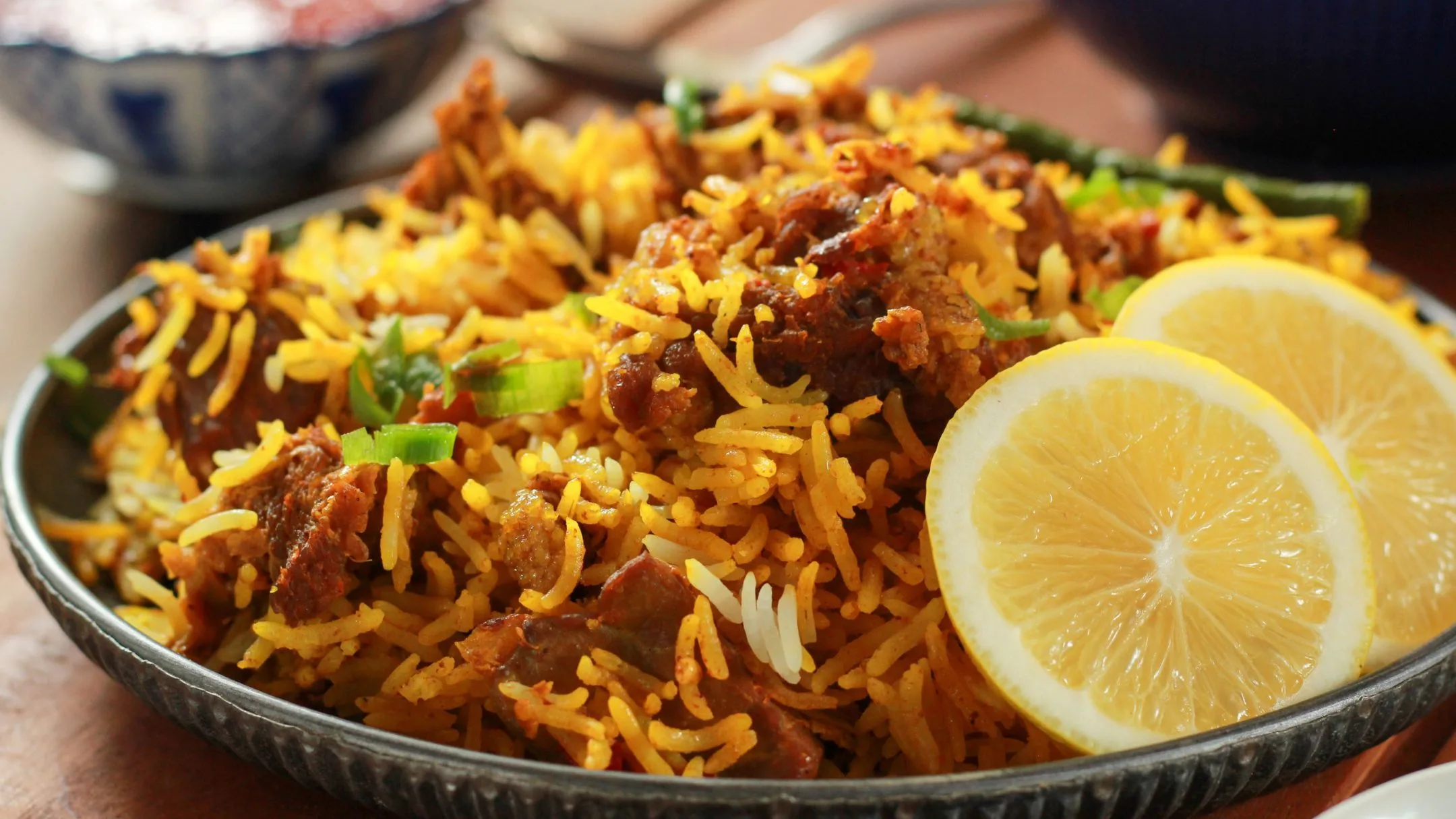 cooked rice and meat served with lemon